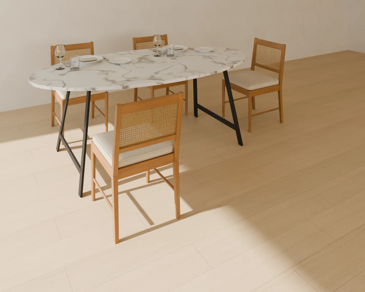 Oval Dining Table styled in a Linden House room with the cane-back dining chair and place setting (sold separately)