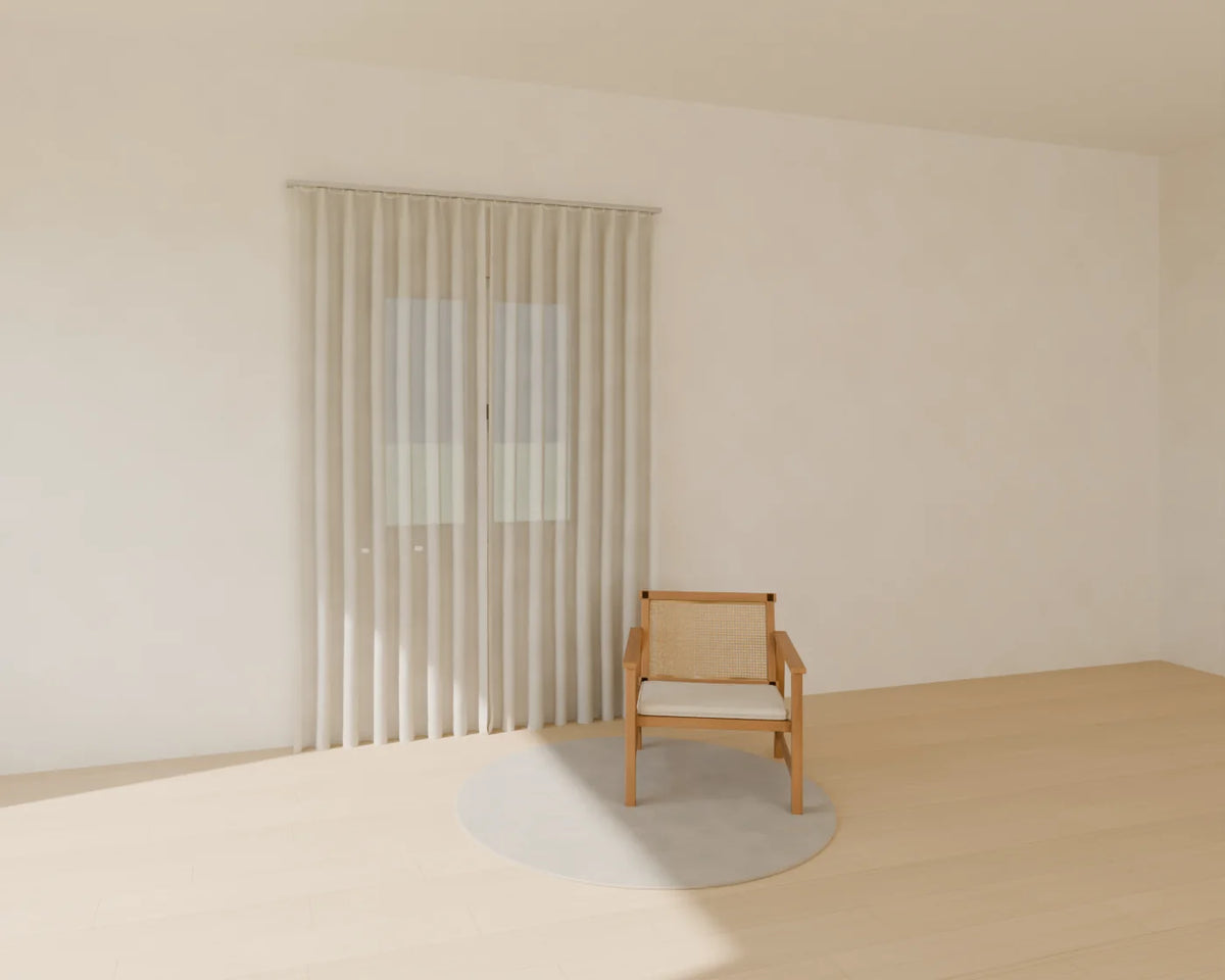 Sheer Curtain Pair styled in a Linden House room with the casement window, cane lounge chair and round rug (sold separately)