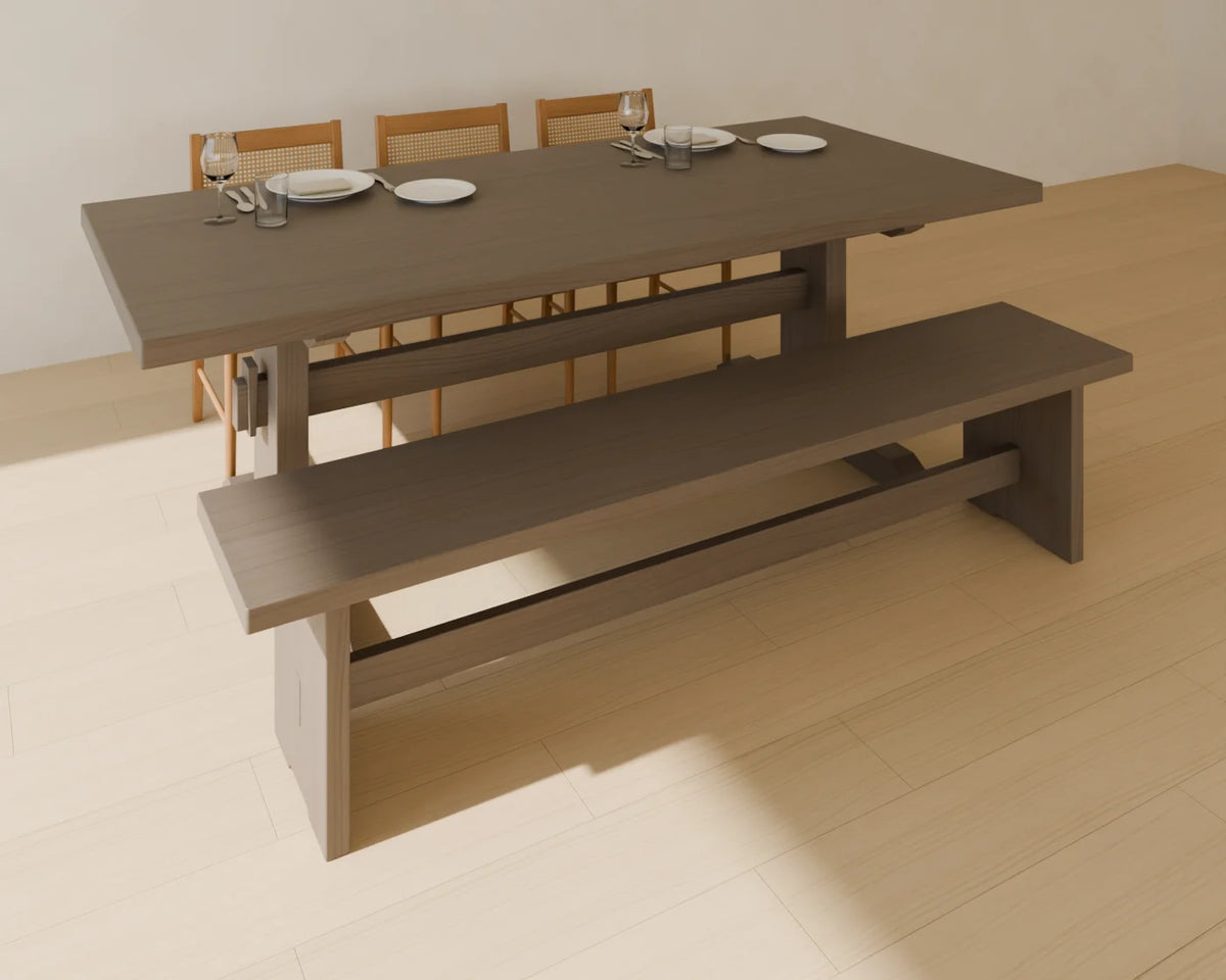Trestle Dining Table styled in a Linden House room with the dining bench, cane-back dining chair and place setting (sold separately)