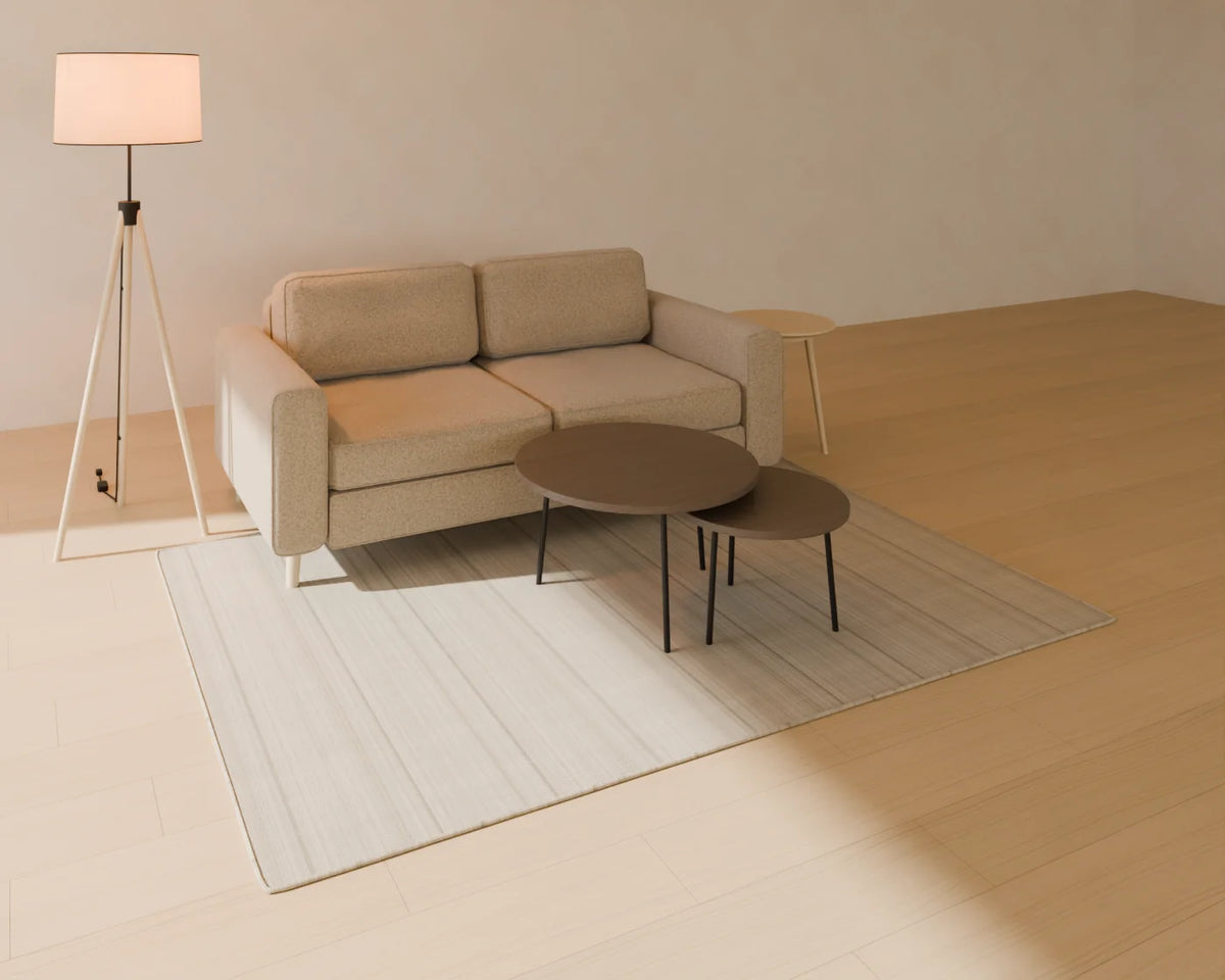 Two-Seat Sofa styled in a Linden House room with the flatweave wool rug, round side table, tripod floor lamp and nesting coffee tables (sold separately)
