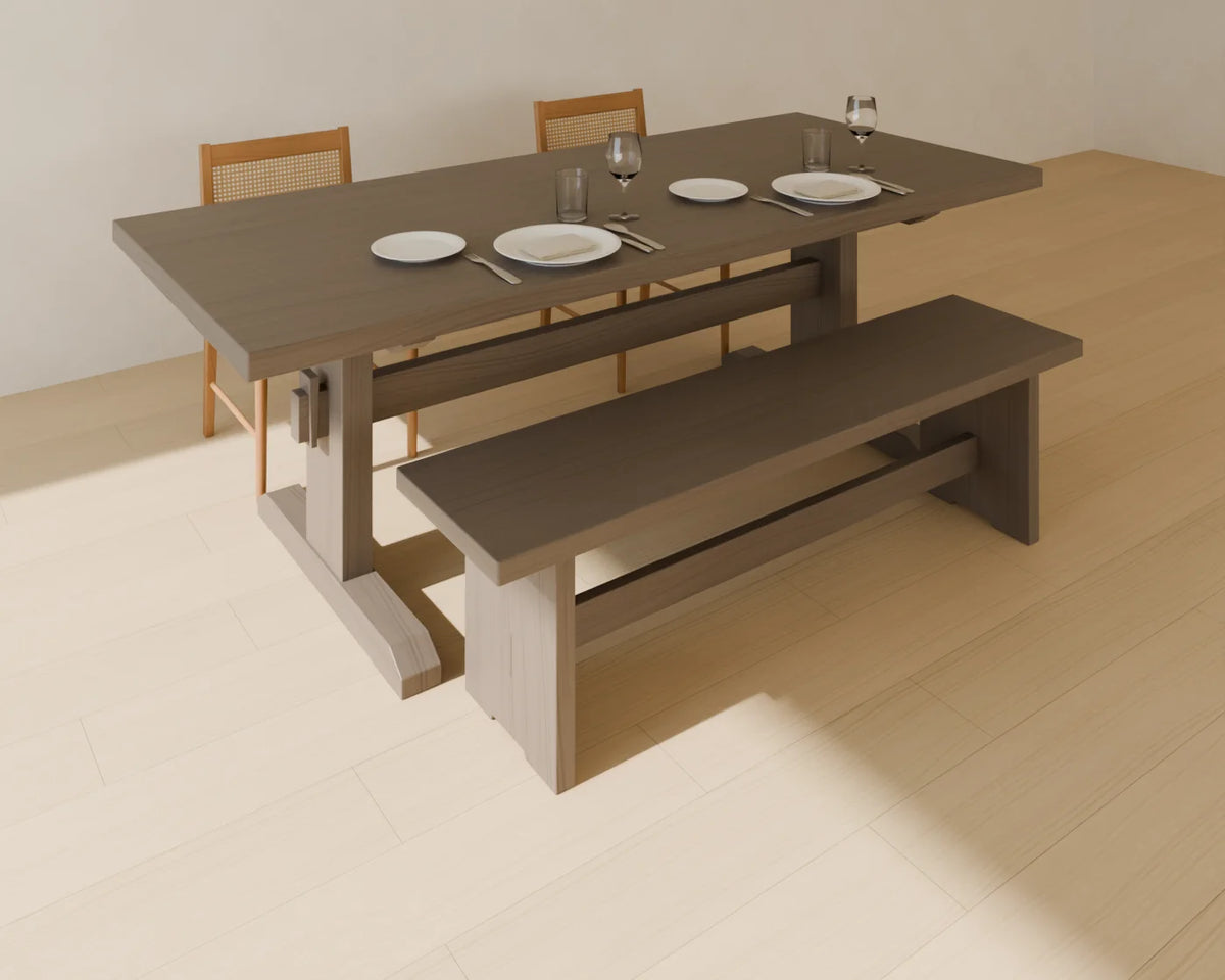 Dining Bench styled in a Linden House room with the trestle dining table, cane-back dining chair and place setting (sold separately)