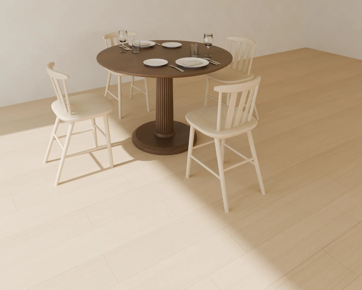 Round Pedestal Dining Table styled in a Linden House room with the wood dining chair and place setting (sold separately)