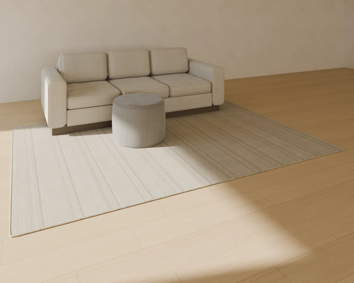 Round Pouf styled in a Linden House room with the three-seat sofa and flatweave wool rug (sold separately)