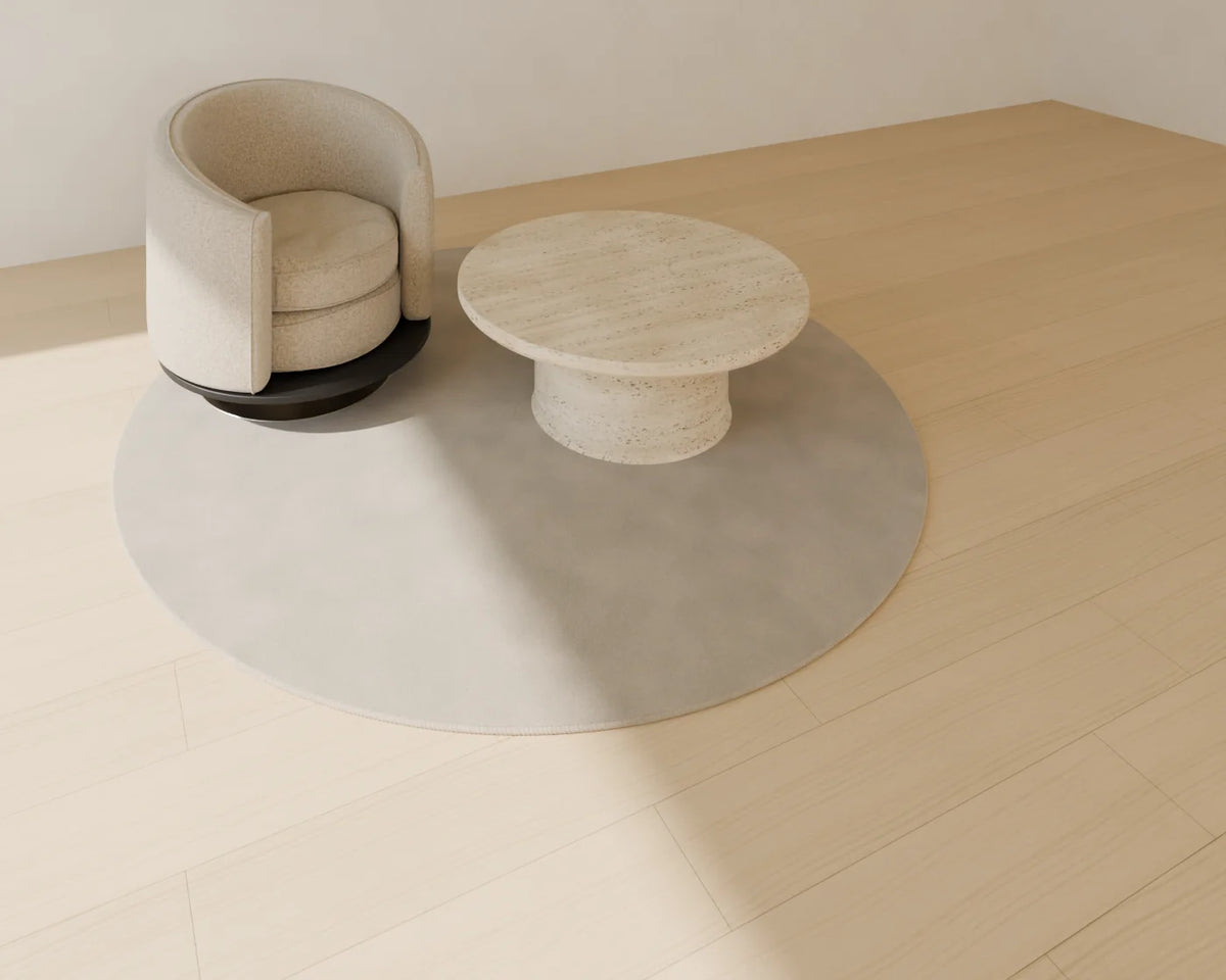 Round Rug styled in a Linden House room with the swivel barrel armchair and round stone coffee table (sold separately)