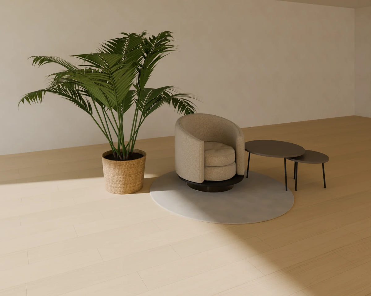 Swivel Barrel Armchair styled in a Linden House room with the round rug, nesting coffee tables and kentia palm in planter (sold separately)