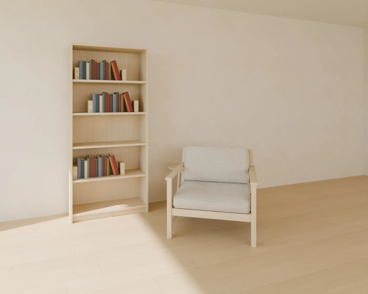 Tall Bookcase styled in a Linden House room with the book row, lounge armchair and round side table (sold separately)