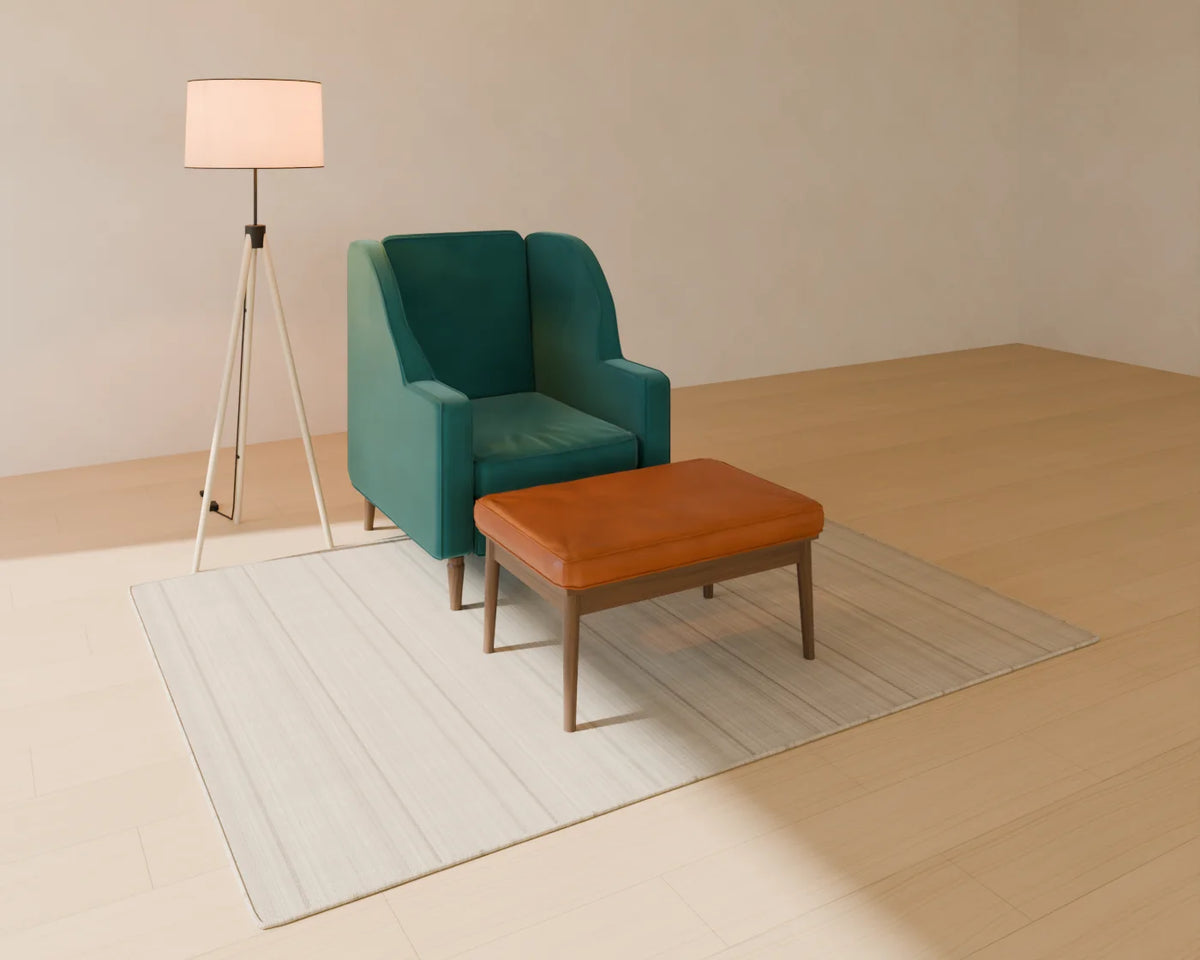 Upholstered Footstool styled in a Linden House room with the wingback armchair, flatweave wool rug and tripod floor lamp (sold separately)