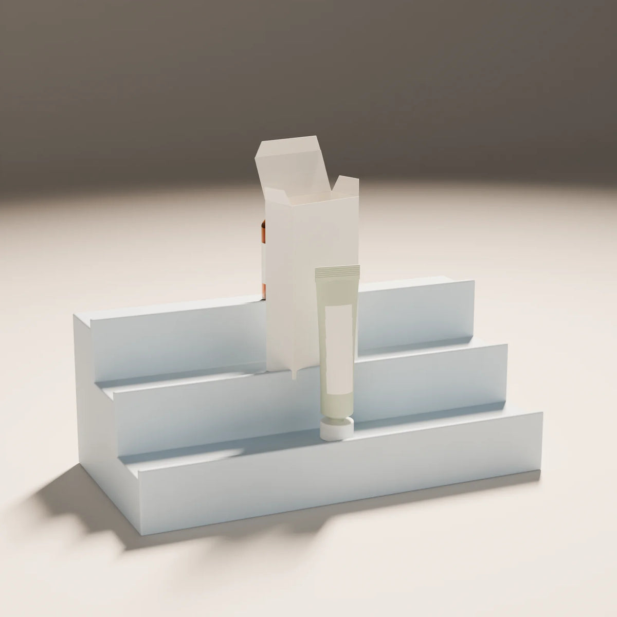 Stepped Bottle Display styled in a Still Studio set with the squeeze tube, folding carton and dropper bottle (sold separately)